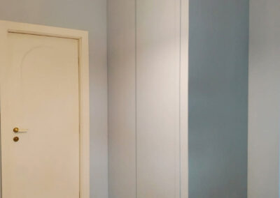 Armadio a muro colorato tutt'uno con la parete